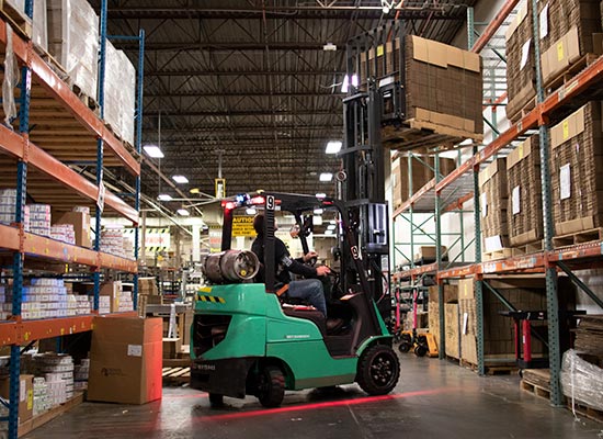 Mitsubishi Forklift Working Between Aisles in a Rimports Warehouse